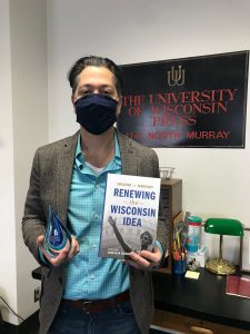 photo of Chad Goldberg holding his book awardholding 