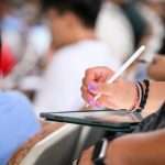 A student writes notes on a tablet on the first day of Math 221 with instructor Soledad Benguria Depassier in Sterling Hall during the first day of fall semester at the University of Wisconsin–Madison on Sept. 6, 2023. (Photo by Althea Dotzour / UW–Madison)
